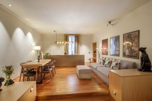 a living room with a couch and a table at Ripetta Luxury Apartments in Rome