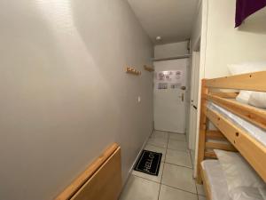 a small room with two bunk beds and a door at L'Armazan in Saint-Lary-Soulan