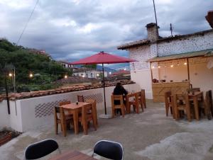 a person sitting at a table on a patio at Te MuzzeU Hostel in Berat