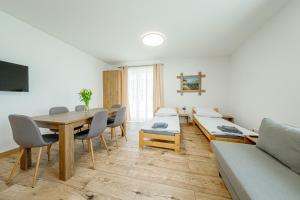 a living room with a table and chairs and a couch at Stara Piekarnia - Kołobrzeska in Olsztyn