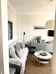 a living room with a white couch and a table at Socratous House in Salamina