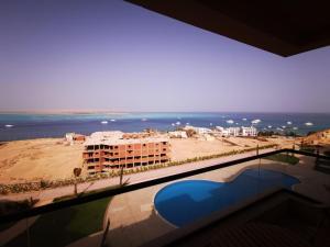 a view of the beach from a balcony of a building at The View hotel in Hurghada