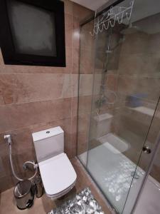 a bathroom with a toilet and a glass shower at The View hotel in Hurghada