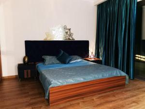 a bedroom with a large bed with a blue bedspread at The View hotel in Hurghada