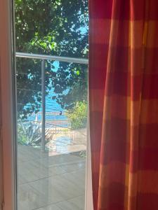 a sliding glass door with a view of a patio at Apartmani Stikovic in Dobra Voda