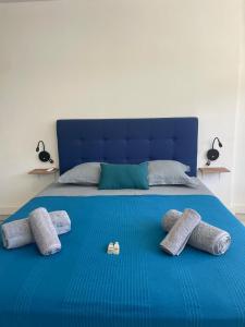 a blue bed with four pillows on it at A340 citi center room in Papeete