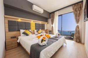 a bedroom with two beds and a large window at La Vita Hotel marmaris in Marmaris
