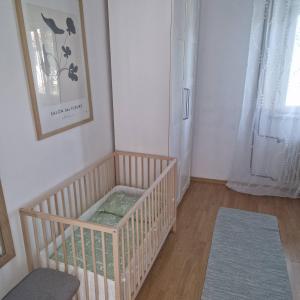 a nursery with a crib in a room at Rosemary apartment in Izola