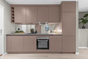 a kitchen with white cabinets and a stove at Modern in a luxurious area - Super central - 6 pax in Oslo +32 photos