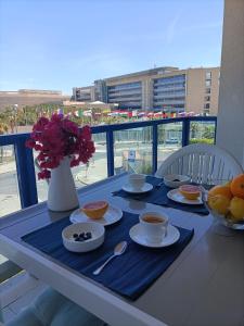 a table with bowls of food on a balcony at Alicante Mar in Alicante