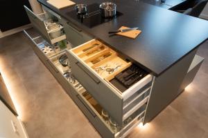 a kitchen with a black counter top with an open drawer at Ferienwohnung am Großen Garten Dresden in Dresden