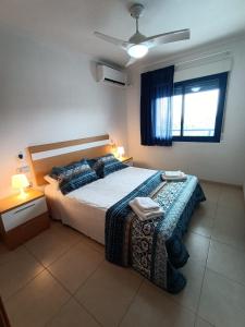 a bedroom with a large bed and a window at Alicante Mar in Alicante