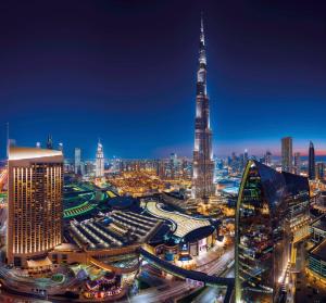 a city at night with the worlds tallest building at Kempinski Central Avenue Dubai in Dubai