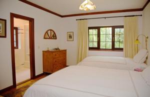 um quarto com 2 camas brancas e uma janela em Acorn Cottage em Glenbeigh