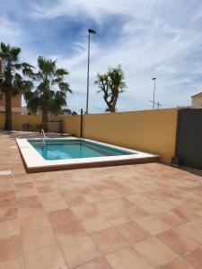 a swimming pool in the middle of a patio at King`s Apartaments in San Javier