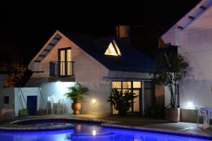 a house with a swimming pool at night at El Camino Los Lanceros in Melgar