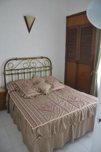 ein Schlafzimmer mit einem Bett mit einer Decke darauf in der Unterkunft El Camino Los Lanceros in Melgar