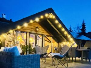 a cabin with lights on the roof at night at Chalet - Kleines Paradies - in Appenzell