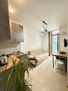 a living room with a couch and a table at Aqua Batumi 47 in Batumi