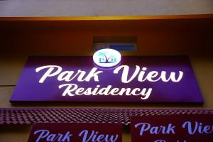 a neon sign for a park view restaurant at Park View Residency in Pondicherry