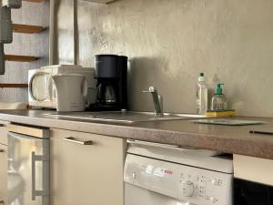 a kitchen with a counter top with a coffee maker at Maison des 4 Saisons by Melrose in Bayeux
