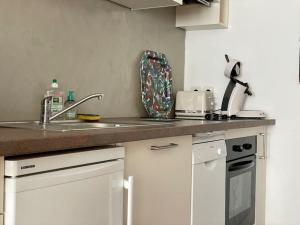 a kitchen with a sink and a counter top at Maison des 4 Saisons by Melrose in Bayeux