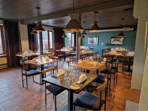 a dining room with wooden tables and chairs at Pesa Hotel in Põlva