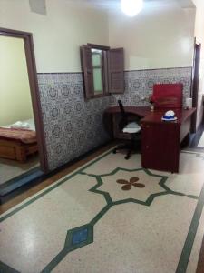 a room with a desk and a chair in a room at hotel appart inezgane agadir in Inezgane