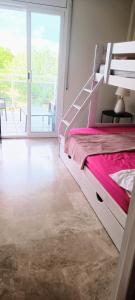 a bedroom with a large white bed and a balcony at APPART STANDING 2 chambres 2SDB clim PISCINE PARKING WIFI TERRASSE 21m2 LOCAL VELO Port-Aventura, plage, centre in Salou