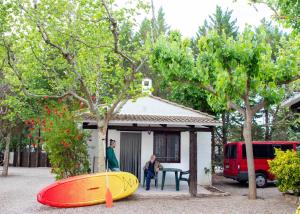 two people sitting in front of a house with two surfboards at TAIGA Lake Caspe in Caspe +79 photos