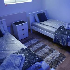 a room with a couch and a bed and a dresser at Apartman Djukic Sokobanja 1 in Soko Banja