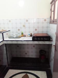 a kitchen with a stove and a counter top at hotel appart inezgane agadir in Inezgane