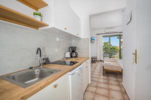 a kitchen with a sink and a counter at 123 Soleil Studios in Agia Marina Aegina