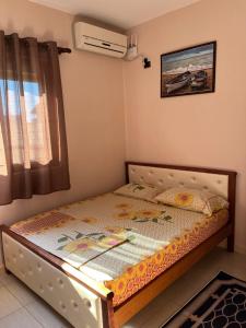 a small bed in a bedroom with a window at Hotel Elsaidi in Velipojë