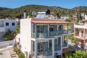 an image of a building with a balcony at 123 Soleil Studios in Agia Marina Aegina
