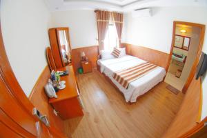 Postel nebo postele na pokoji v ubytování Kieu Anh Hotel Vung Tau
