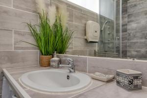 a bathroom with a sink and a mirror at Le Cosy à la grande pyramide in La Grande-Motte +19 photos