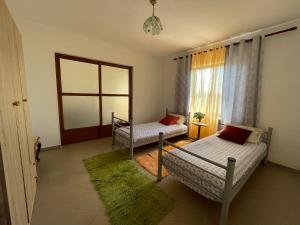 a living room with two beds and a window at Countriside Holiday Villa 