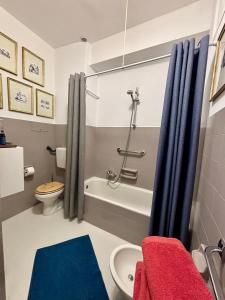 a bathroom with a tub and a toilet and a sink at Casa Aricò & Shatulle Suites in Taormina
