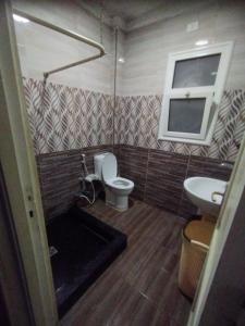 a bathroom with a toilet and a sink at مدينتى in Madinaty