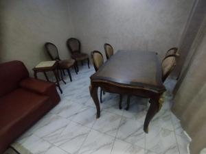 a living room with a wooden table and chairs at مدينتى in Madinaty