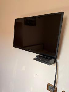 a flat screen tv sitting on top of a wall at Hotel Elsaidi in Velipojë