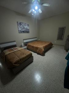 Postel nebo postele na pokoji v ubytování Chaltan Apartments