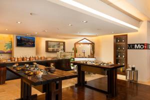 a restaurant with two tables in a room at Courtyard by Marriott Pune Hinjewadi in Pune