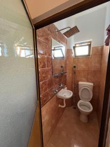 a bathroom with a toilet and a sink at Hotel Elsaidi in Velipojë +39 photos