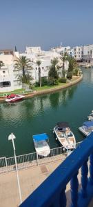 two boats are docked in a river with buildings at Appartement de luxe au coeur de la marina Hammamet in Hammamet +18 photos