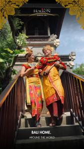 two women are walking down some stairs at Horison Ultima Seminyak Bali - CHSE Certified in Seminyak