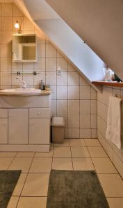 a bathroom with a sink and a toilet in a attic at Dworek Wołyński - Winnica Zegartowice 