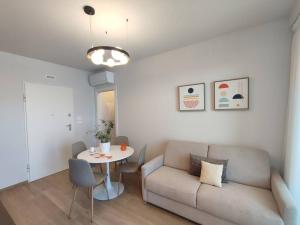a living room with a couch and a table at Suite Exclusive a due passi dal mare posto auto in San Benedetto del Tronto