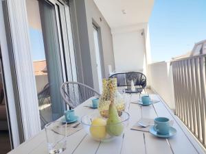 a table on a balcony with a table with fruit on it at Suite Exclusive a due passi dal mare posto auto in San Benedetto del Tronto